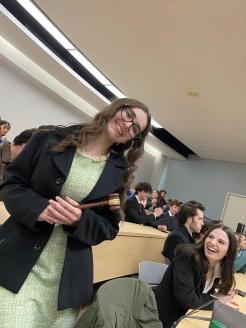 Member of the Utica Mock Trial tema holds a gavel at the 2023 regionals.