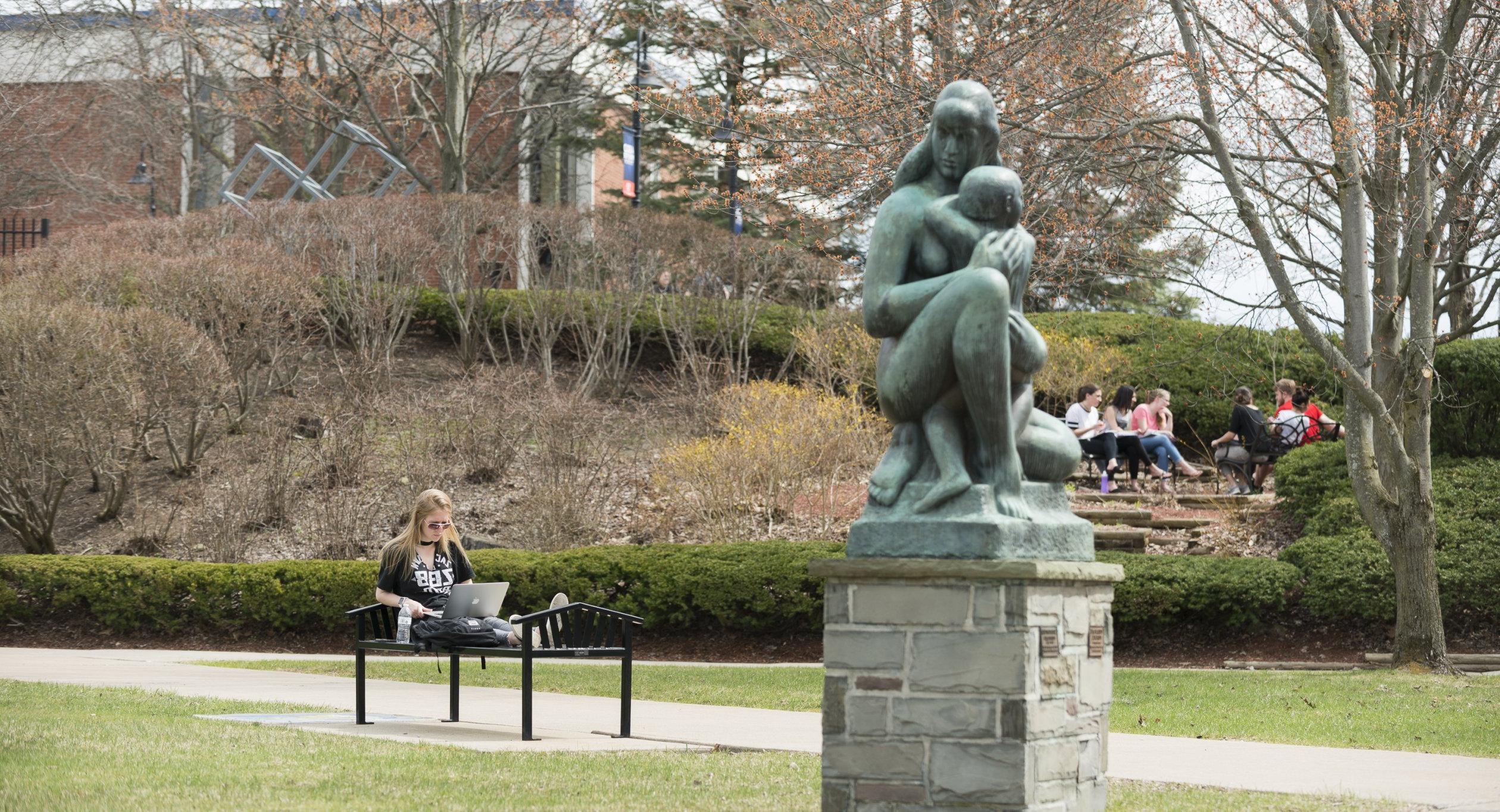 Campus Scenic Spring - Students work near statue