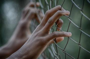 Hands in fence - Human rights generic